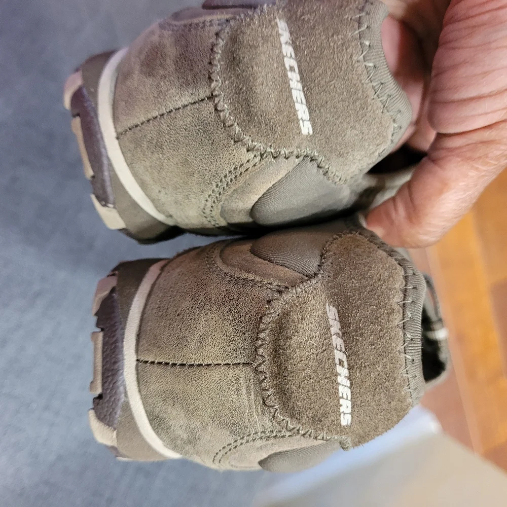 Skechers green outlined with gold ad gray. Slip on.